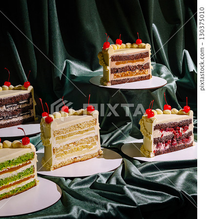 Layers of vibrant cakes in various flavors are neatly arranged on circular bases Layers of vibrant cakes in various flavors are neatly arranged on circular bases 130375010