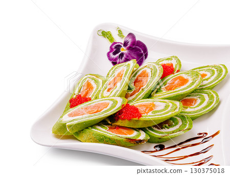 Exquisite green sushi rolls garnished with fish roe and sauce presentation 130375018