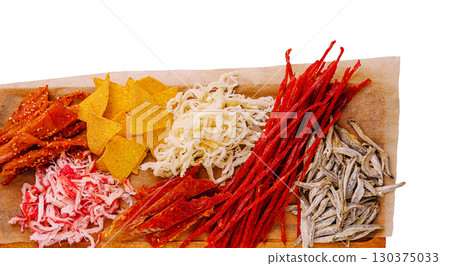 Colorful assortment of dried seafood and snacks on wooden platter Colorful assortment of dried seafood and snacks on wooden platter 130375033