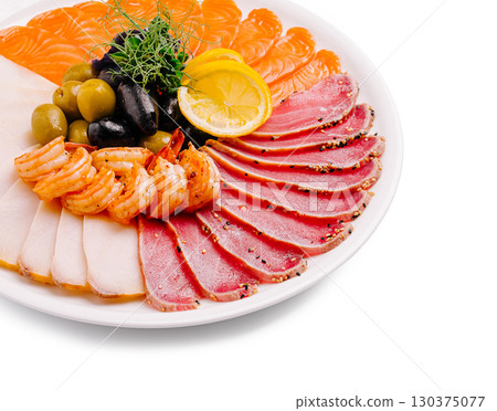 Elegant seafood platter showcasing fresh fish and shrimp on a white plate Elegant seafood platter showcasing fresh fish and shrimp on a white plate 130375077