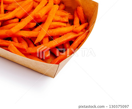Crispy and vibrant sweet potato fries served in a paper tray Crispy and vibrant sweet potato fries served in a paper tray 130375097