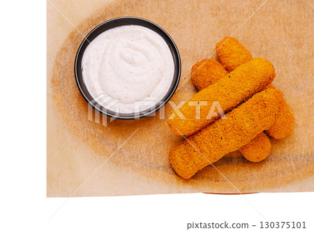 Crispy golden fried snacks served with creamy dipping sauce 130375101