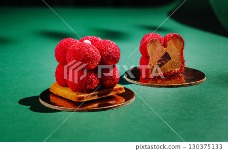 Delicious desserts presented on green surface with intricate details 130375133