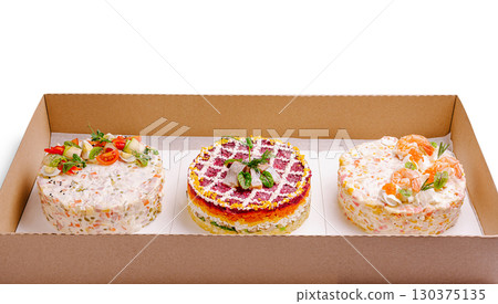 Three visually appealing Russian salads are neatly arranged in a cardboard box 130375135
