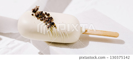 Delicious white chocolate ice cream treat topped with cookie crumbs Delicious white chocolate ice cream treat topped with cookie crumbs 130375142