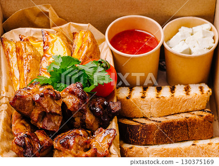 Delicious grilled meat platter with bread and sauces from local eatery Delicious grilled meat platter with bread and sauces from local eatery 130375169
