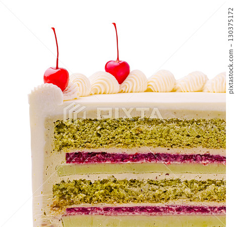 Delicious cake with layers of green and pink frosting topped with cherries Delicious cake with layers of green and pink frosting topped with cherries 130375172