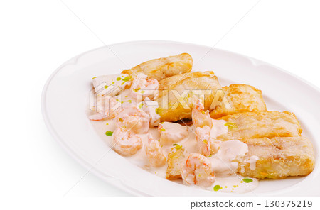 Delicious seafood dish with shrimp and crispy plantains served on a plate Delicious seafood dish with shrimp and crispy plantains served on a plate 130375219