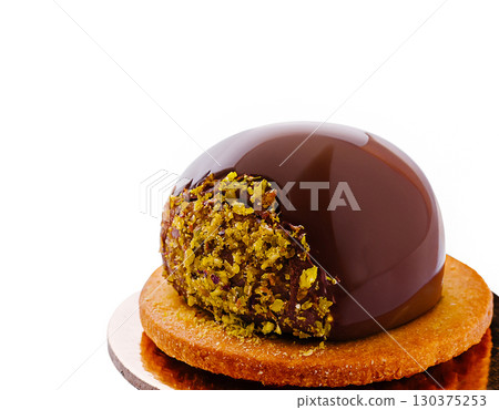 Decadent chocolate pastry dessert with pistachio layer and cookie base Decadent chocolate pastry dessert with pistachio layer and cookie base 130375253