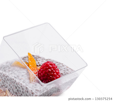 Chia seed pudding topped with fresh raspberries and orange slices 130375254