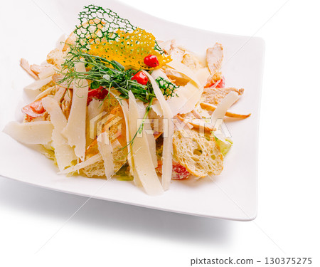 Gourmet salad with chicken and crunchy toppings served on a plate 130375275