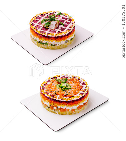 Colorful layered fish salad cakes displayed on white plates in a bright setting Colorful layered fish salad cakes displayed on white plates in a bright setting 130375301
