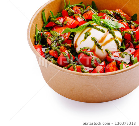 Fresh burrata salad with tomato, basil, and creamy cheese served in a bowl 130375318
