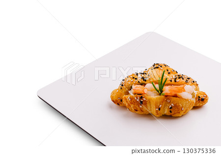 Delicate pastry filled with shrimp and herbs on a clean plate Delicate pastry filled with shrimp and herbs on a clean plate 130375336