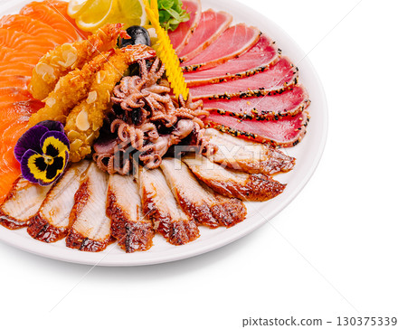 Savoring assorted seafood platter with fresh garnishments 130375339