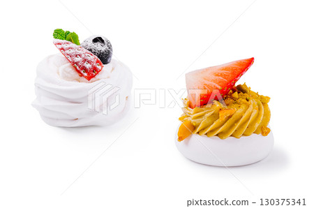 Delicious meringue desserts decorated with fresh fruit and cream Delicious meringue desserts decorated with fresh fruit and cream 130375341