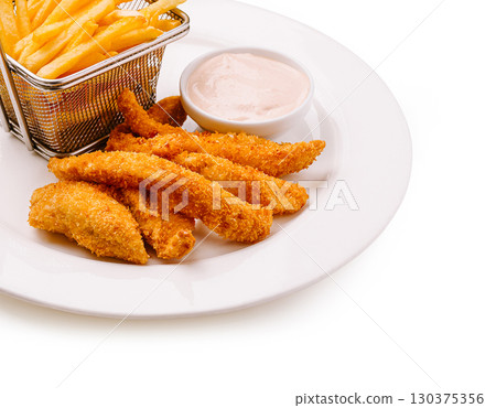 Crispy chicken tenders with golden fries served on a white plate 130375356