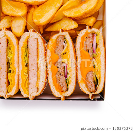 Delicious assortment of hot dogs and golden fries served in a takeout box 130375373