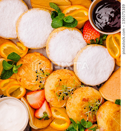 Delightful cottage cheese pancakes platter featuring tropical fruits and sweet treats Delightful cottage cheese pancakes platter featuring tropical fruits and sweet treats 130375389