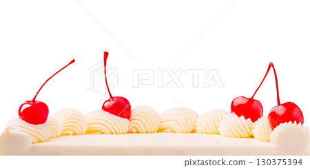 Delicious white cake topped with cherries and whipped cream decoration 130375394