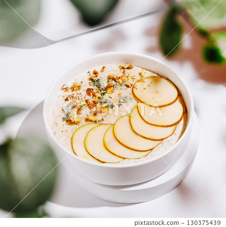 Creamy dessert bowl with sliced fruits and nuts garnished for a fresh look Creamy dessert bowl with sliced fruits and nuts garnished for a fresh look 130375439