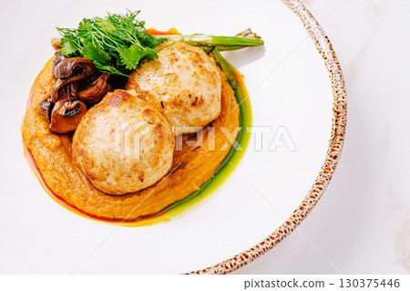 Chicken patties with vegetable puree, mushrooms and herbs on white plate Chicken patties with vegetable puree, mushrooms and herbs on white plate 130375446