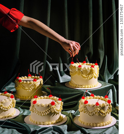 Creative cake decoration in a stylish setting during a festive occasion Creative cake decoration in a stylish setting during a festive occasion 130375467