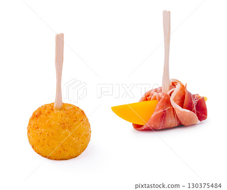 Gourmet snacks featuring cheese and prosciutto on wooden pick sticks 130375484