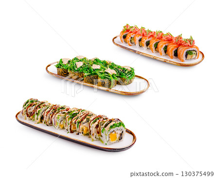 Delicious sushi rolls served on elegant platters in a bright setting Delicious sushi rolls served on elegant platters in a bright setting 130375499