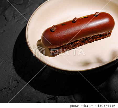Elegant chocolate dessert on dark plate for gourmet dining 130375556