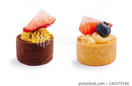 Delicious miniature desserts with fruit toppings at a bakery display Delicious miniature desserts with fruit toppings at a bakery display 130375590