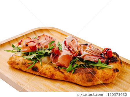 Delicious Italian focaccia topped with fresh ingredients served on wood 130375680