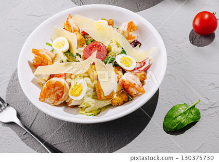 Delicious salad with shrimp, eggs, and vegetables served in a bowl Delicious salad with shrimp, eggs, and vegetables served in a bowl 130375730