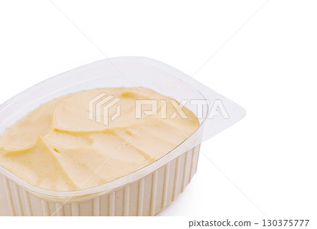Plastic container with mayonnaise sauce isolated on white Plastic container with mayonnaise sauce isolated on white 130375777
