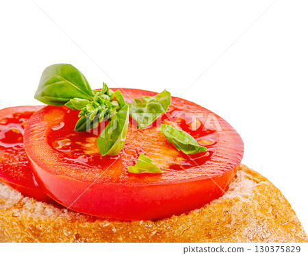 Delicious tomato and basil topping on fresh bread slice Delicious tomato and basil topping on fresh bread slice 130375829