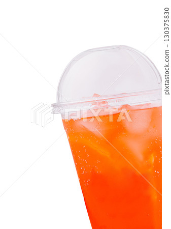 Refreshing iced beverage with vibrant orange color in clear cup Refreshing iced beverage with vibrant orange color in clear cup 130375830