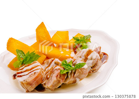 Delicious pork tenderloin with sweet potatoes and herb garnish served elegantly 130375878
