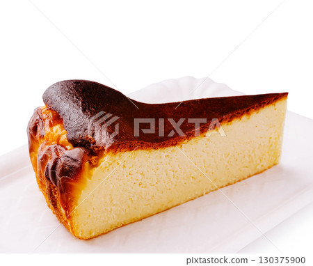 Delicious baked cheesecake slice with golden brown crust on a plate 130375900