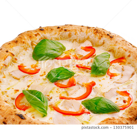 Delicious pizza topped with fresh basil and red peppers served at a pizzeria 130375901