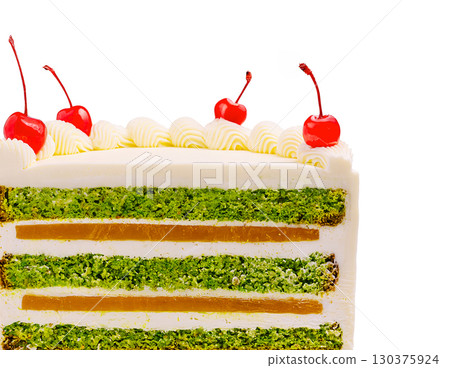 Delicious layered cake with cherries on top and vibrant green filling 130375924