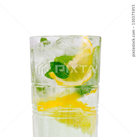 Refreshing mojito cocktail served in a glass with ice and lemon slices 130375955
