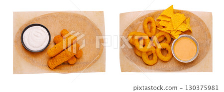 Variety of crispy snacks served with dips on a wooden platter 130375981