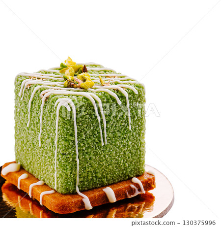 Unique green dessert on a plate with decorative drizzle and nuts Unique green dessert on a plate with decorative drizzle and nuts 130375996