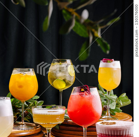 Colorful cocktails arranged beautifully on a wooden table in a lively setting 130376000