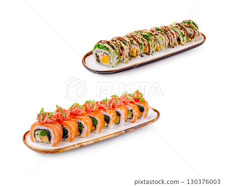 Colorful sushi rolls displayed on elegant plates at a restaurant setting 130376003