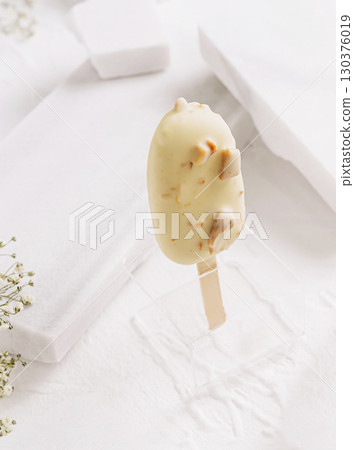 Delicious ice cream treat with nuts presented in a minimalistic setting 130376019