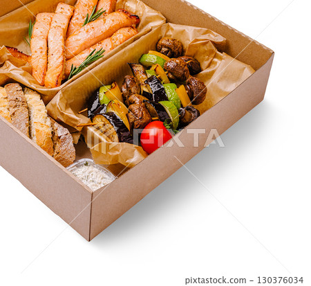 Savory grilled salmon and vegetables in a takeout box for lunch Savory grilled salmon and vegetables in a takeout box for lunch 130376034