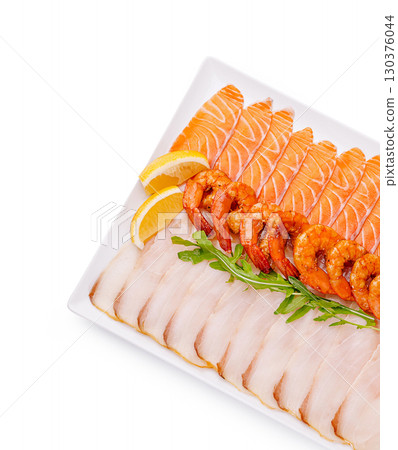 Fresh sushi platter featuring assorted seafood and garnishes for sharing 130376044