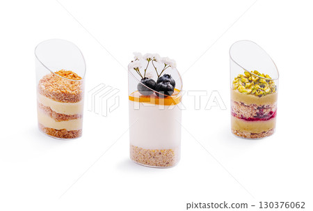 Dessert cups featuring layers of cream, fruit, and nuts in a modern presentation Dessert cups featuring layers of cream, fruit, and nuts in a modern presentation 130376062