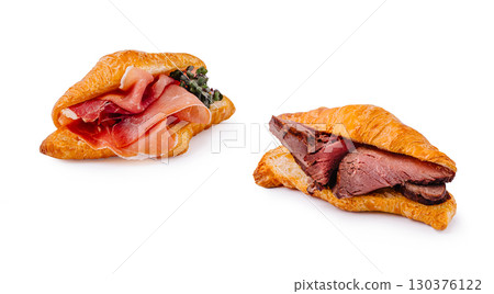 Delicious croissants filled with various meats on white background Delicious croissants filled with various meats on white background 130376122